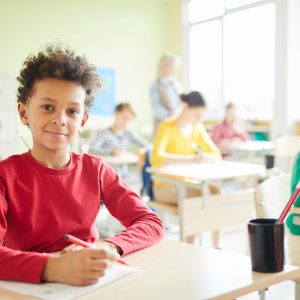 Student writing a school test for IEP evaluation support