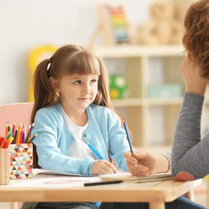 Child in art therapy session for school support planning